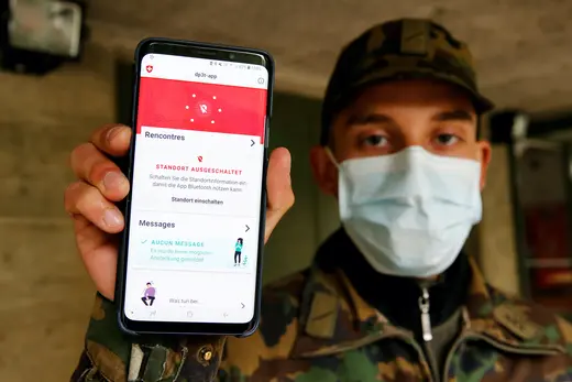 A Swiss soldier shows on a mobile device the contact tracking application created by the Swiss Federal Institute of Technology Lausanne.