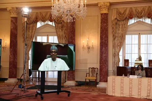 Nigerian President Muhammadu Buhari is seen on a television screen speaking during a virtual visit to the U.S. State Department, in which he spoke with U.S. Secretary of State Antony Blinken.