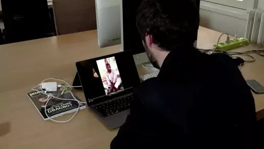 A man watches a video on a tablet showing a French journalist in captivity making a plea for his release.