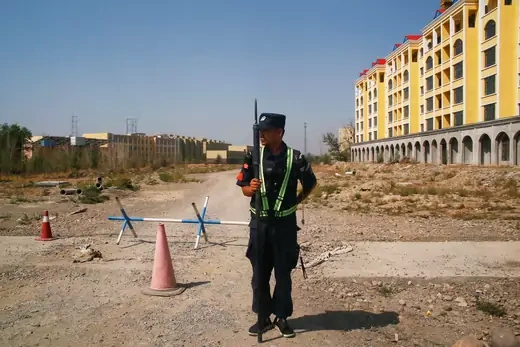 A Chinese police officer takes his position by the road near what is officially called a vocational education centre in Yining in Xinjiang Uighur Autonomous Region, China on September 4, 2018.
