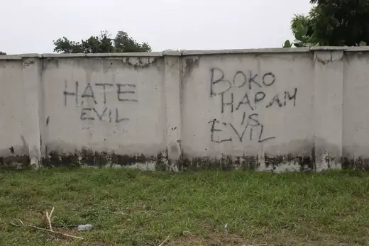 A wall that has "Hate Evil" and "Boko Haram is Evil" scrawled on it.