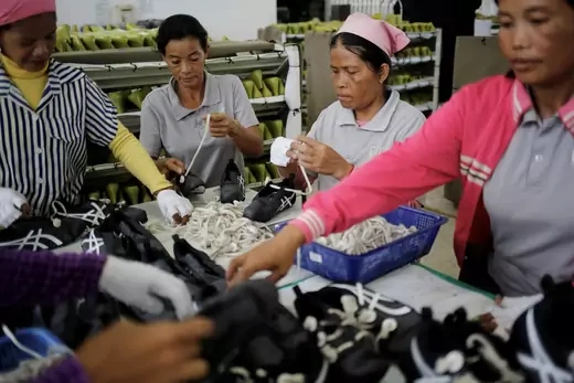 Women work on the production line at Complete Honour Footwear Industrial, a footwear factory owned by a Taiwan company, in Kampong Speu, Cambodia, July 5, 2018.