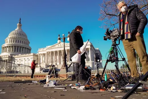 Members of the news media survey damaged equipment outside the U.S. Capitol a day after supporters of U.S. President Donald Trump occupied the Capitol in Washington