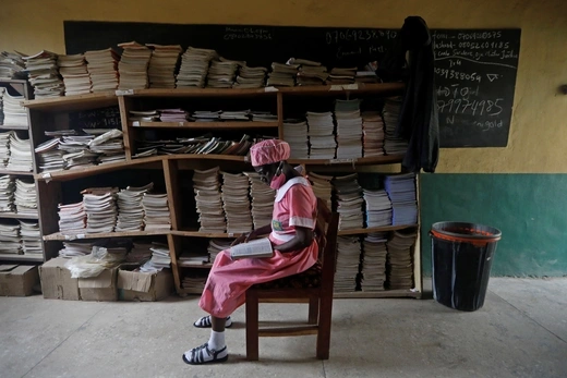 Shade Ajayi, 50, reads a book as she sits in the library at Ilorin Grammar School in Ilorin, Kwara state, March 24, 2021. Ajayi intends to continue her education for four more years, saying it will help her business. "People around me can read and write and they are succeeding in their businesses," she said.