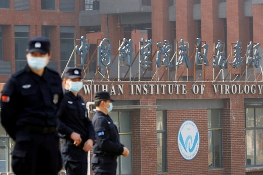 FILE PHOTO: Security personnel keep watch outside the Wuhan Institute of Virology during the visit by the World Health Organization (WHO) team tasked with investigating the origins of the coronavirus disease (COVID-19), in Wuhan, Hubei province, China, February 3, 2021.