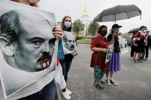 Ukrainian activists hold up posters depicting Belarusian President Alexander Lukashenko at a rally in Kyiv supporting the detained Belarusian journalist and blogger Roman Protasevich, May 28, 2021.