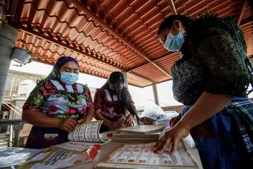 Indigenous Zapotec women, who are selected as polling station officers by the National Electoral Institute (INE), count ballots as authorities continue the distribution of voting materials ahead of the mid-term elections on June 6, in the rural village of San Bartolome Quialana, in Oaxaca state, Mexico May 31, 2021.