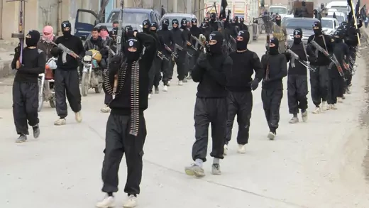 Fighters of  al-Qaeda linked Islamic State of Iraq and the Levant carry their weapons during a parade. 