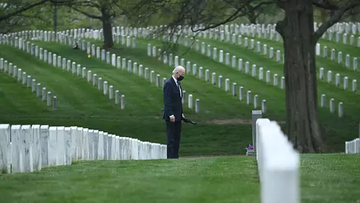 U.S. President Joe Biden walks through Arlington National Cemetery in April 2021 to honor fallen veterans of the Afghan conflict.