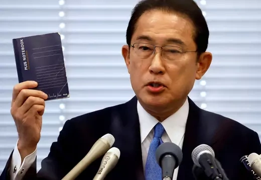 Fumio Kishida, Japan's ruling Liberal Democratic Party (LDP) lawmaker and former foreign minister, shows his notebook during a news conference as he announces his candidacy for the party's presidential election.