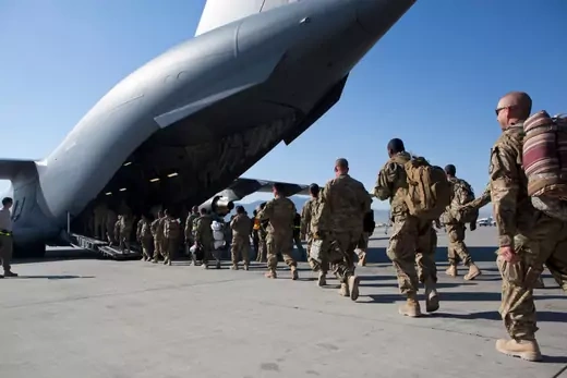 Army soldiers walk to their C-17 cargo plane for departure May 11, 2013 at Bagram Air Base, Afghanistan. U.S. soldiers and marines are part of the NATO troop withdrawal from Afghanistan, to be completed by the end of 2014.