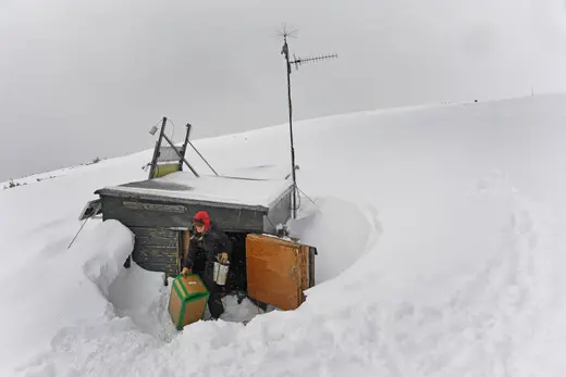A climate technician unloads equipment at the extremely snowy Niwot Ridge NOAA research site in Colorado. 