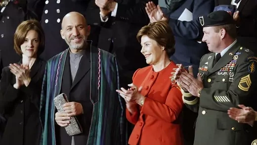 Afghan leader Hamid Karzai attends the 2002 State of the Union address alongside U.S. First Lady Laura Bush.