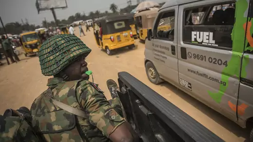 A Nigerian soldier rides in a truck with a whistle in his mouth during a military patrol in a pro-Biafra zone in the southeastern city of Aba.