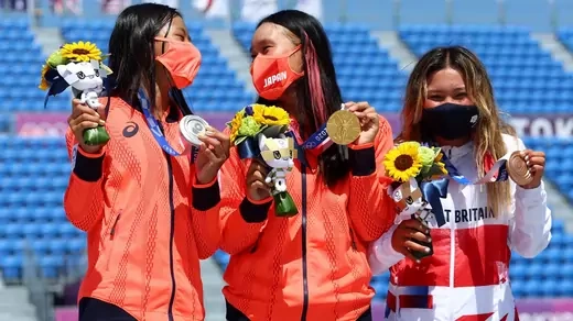 Sakura Yosozumi, Cocona Hiraki, and Sky Brown celebrate their respective gold, silver, and bronze medals for skateboarding at the 2021 Tokyo Olympic Games.
