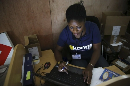 A woman inputs data into a computer at the Konga online shopping company warehouse in Lagos. 