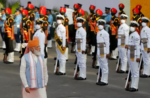 Indian Prime Minister Narendra Modi walks down a red carpet inspecting lines of troops and honor guard during Independence Day celebrations at the historic Red Fort in Delhi, India on August 15, 2021.