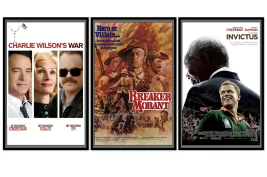 Three movie posters in black frames. From left: Charlie Wilson's War (a man, woman, and another man in sunglasses look out); Breaker Morant (three men in military uniforms stand over scenes of combat); Invictus (a man in a green and yellow rugby uniform looks triumphant in front of a crowd with Morgan Freeman as Nelson Mandela behind him).
