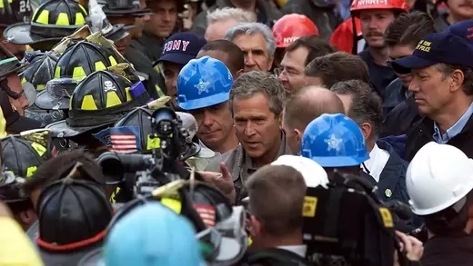 President George W. Bush speaks with firefighters and rescue personnel at New York’s ground zero on September 14.