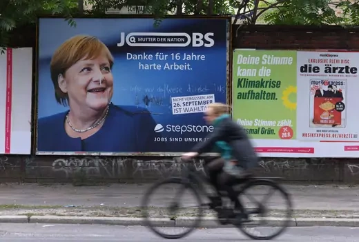 A billboard advertising for a jobs recruiting firm shows German Chancellor Angela Merkel and reads: "Thanks for 16 years of hard work" next to a smaller election poster for the German Greens Party ahead of federal parliamentary elections on September 19, 2021 in Berlin, Germany.