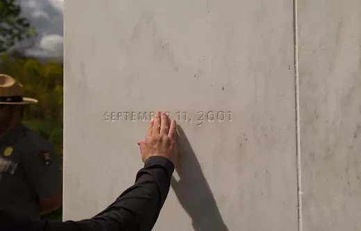A visitor traces the date etched in a marble slab on the Wall of Names at the Flight 93 National Memorial before the 15th Anniversary of the September 11th terrorist attacks, September 11, 2016 in Shanksville, PA. United Airlines Flight 93 crashed into a field outside Shanksville, PA with 40 passengers and 4 hijackers aboard on September 11, 2001.