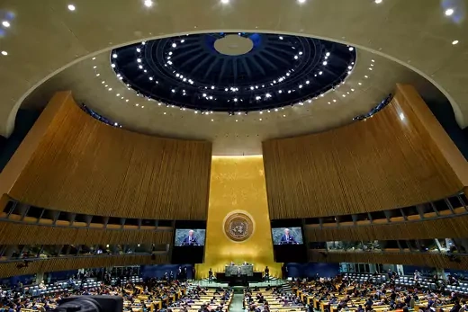 A wide shot of the UN General Assembly Chamber as President Biden speaks. 