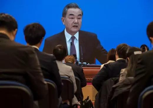Chinese and foreign journalists watch as China's Foreign Minister Wang Yi, on screen, answers a question during a video news conference, held remotely as a precaution for COVID-19, as part of the National People's Congress on March 7, 2021 in Beijing, China.