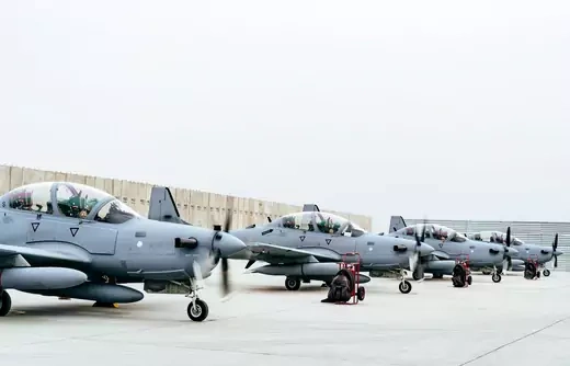 Four A-29 Super Tucanos wait at an airbase.