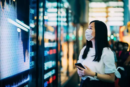 Women stares at stock exchange market display screen board
