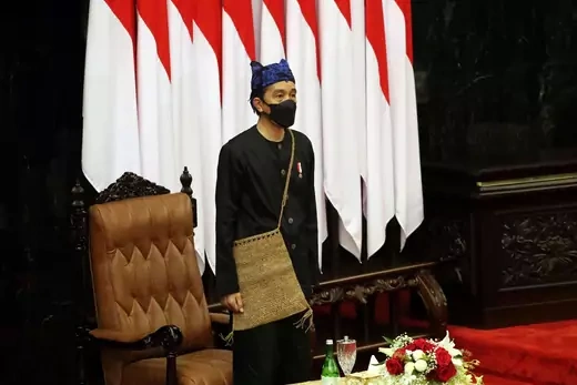 Indonesian President Joko Widodo, wearing traditional Baduy outfit and a protective mask, stands before delivering his State of the Nation Address ahead of the country's Independence Day,
