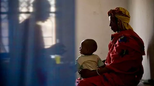 Mother and sick son are consulting with a doctor in Chad.