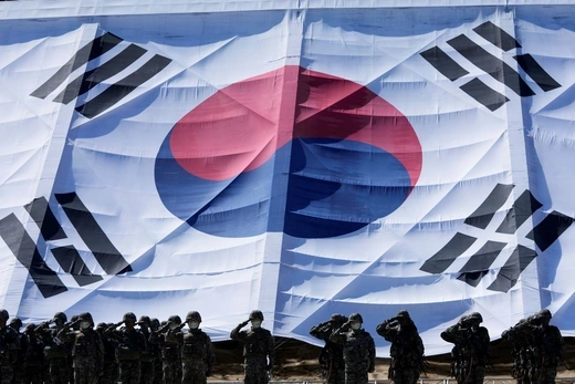 South Korean soldiers salute their country's flag in celebration of Armed Forces Day.