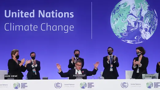 COP26 officials clap.