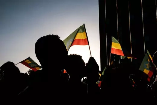People hold Ethiopian flags during a memorial service for the victims of the Tigray conflict organized by the city administration, in Addis Ababa, Ethiopia, on November 3, 2021.