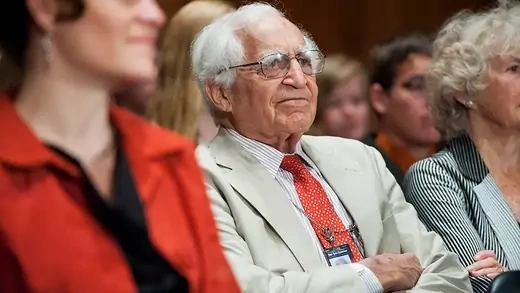 Walter Pincus sitting in a crowd at a Senate Banking, Housing and Urban Affairs Committee hearing.