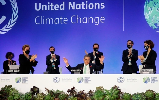 COP26 President Alok Sharma gestures as he receives applause during the UN Climate Change Conference (COP26) in Glasgow.