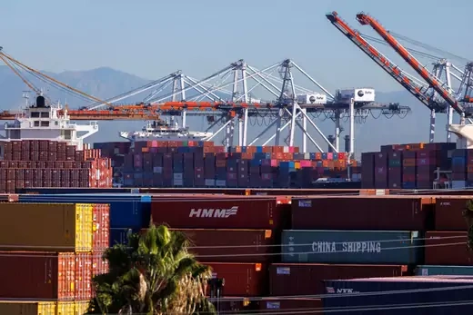 Stacked containers are shown as ships unload their cargo at the Port of Los Angeles in Los Angeles, California, U.S.