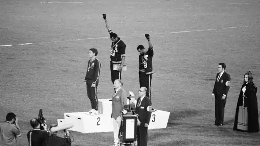 Tommie Smith and John raise their hands in the Black power salute during the medal ceremony.