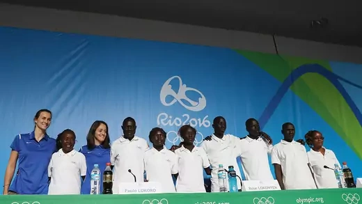 Members of the Refugee Olympic Team pose for a photo during a press conference.