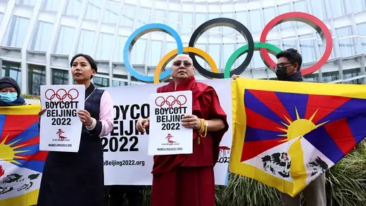 Demonstrators display the Tibetan flag and hold signs saying Boycott Beijing 2022 outside the IOC headquarters.