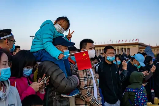 Crowd of people with a Chinese flag