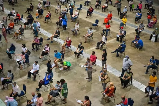 People queue for the Pfizer/BioNTech Covid-19 coronavirus vaccine during the first mega Covid-19 vaccination at the Malaysia International Trade and Exhibition Centre in Kuala Lumpur on May 31, 2021.