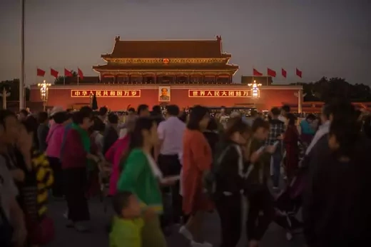 People walk by on Tiananmen square in Beijing on September 28, 2017.