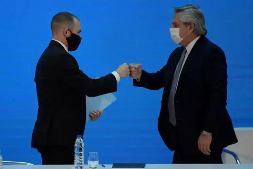 Finance Minister of Argentina Martín Guzmán bumps fists with Argentine President Alberto Fernández