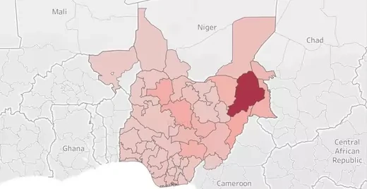 Map of Nigeria shaded in red to reflect Nigeria Security Tracker-documented deaths per state. Borno state, the northeastern-most state, is dark red, while the rest of the country are shades of pink. Regions of Cameroon, Chad, and Niger that have experienced Boko Haram-related violence are also shaded.