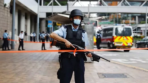 Police officer holding a gun at the high court in Hong Kong, China.