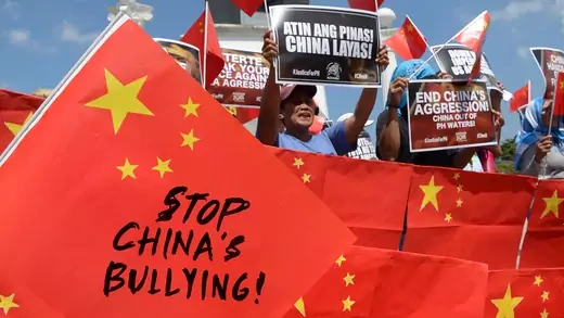 People hold signs during a protest saying "Stop China's Bullying."