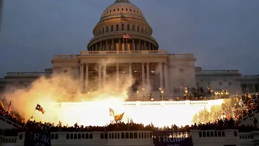 An explosion caused by a police munition is seen during the storming of the U.S. Capitol Building in Washington, January 6, 2021.