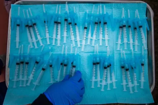 A nurse takes a Moderna Covid-19 vaccines ready to be administered at a vaccination site at Kedren Community Health Center, in South Central Los Angeles, California on February 16, 2021.