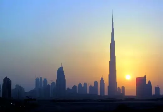 The Burj Khalifa (C) skyscraper is seen as the sun sets over Dubai October 5, 2010.
